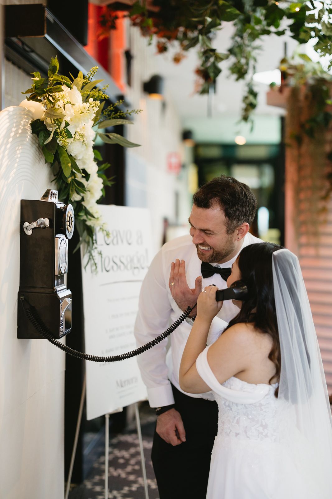 A couple leaving a video message on the Memora vintage phone at their wedding